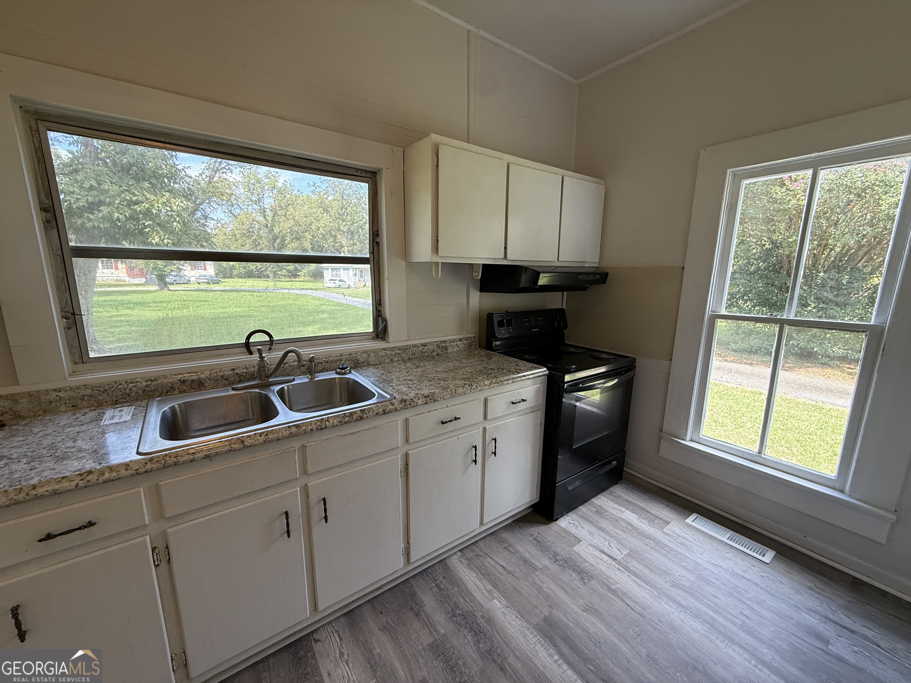 604 Shy Street Dexter, GA 31019 - Photo 35 of 36 a kitchen with a sink wooden floor and a large window