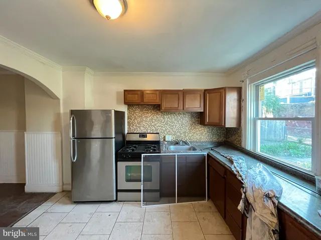 a kitchen with stainless steel appliances a refrigerator sink and cabinets