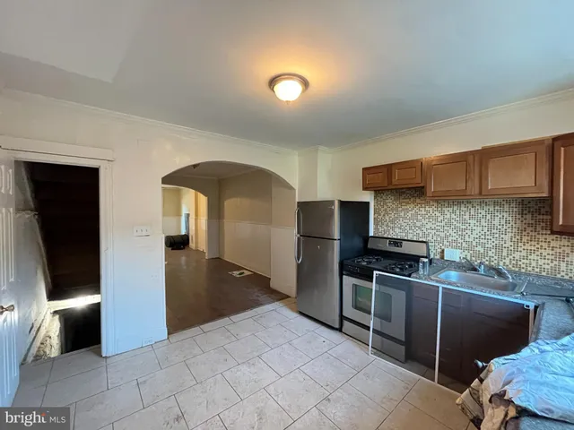a kitchen with stainless steel appliances granite countertop a refrigerator and a stove top oven