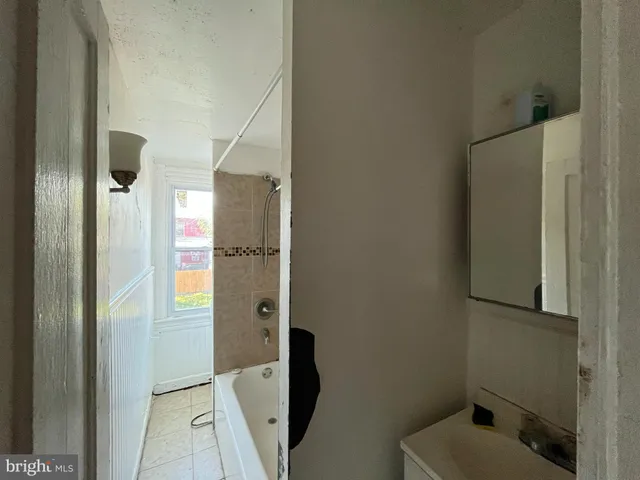 a bathroom with a tub and shower