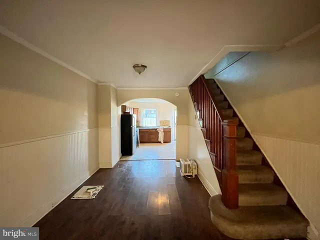 a view of a hallway with wooden floor and staircase