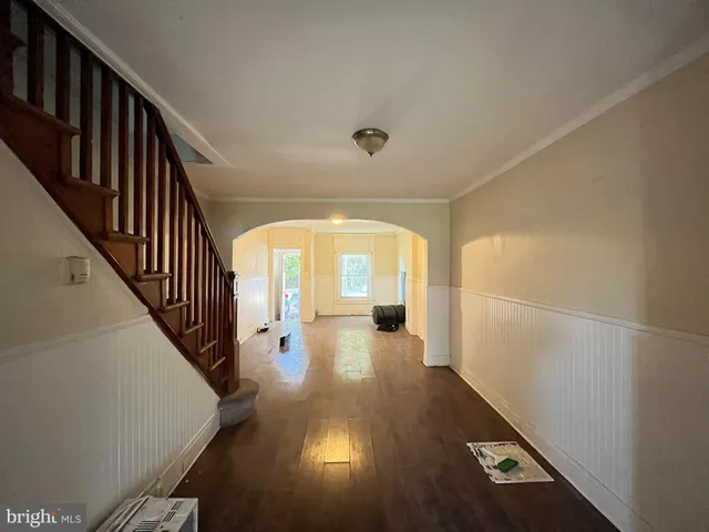 a view of a hallway view with wooden floor and staircase