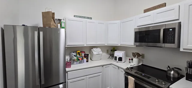 a kitchen with stainless steel appliances a refrigerator and a stove top oven