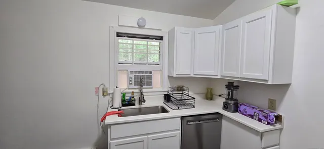 a kitchen with a sink cabinets and utility