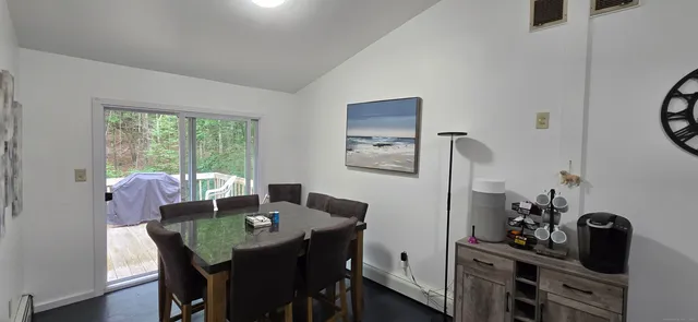 a view of a dining room with furniture and a window