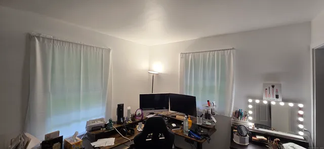 a view of a workspace with furniture and a chandelier