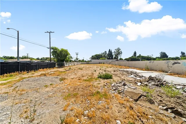 a view of an empty room with floor to ceiling windows and stairs
