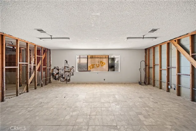 a view of a livingroom with wooden floor and stairs