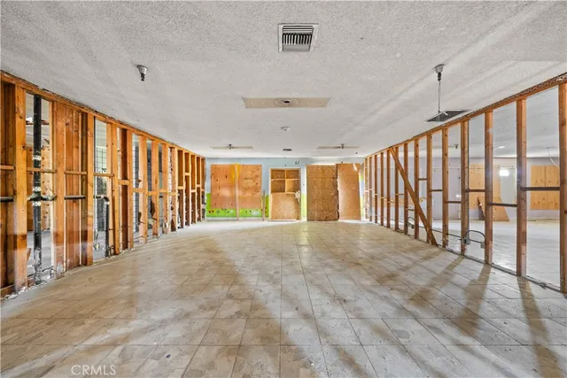 a view of an empty room with a fireplace