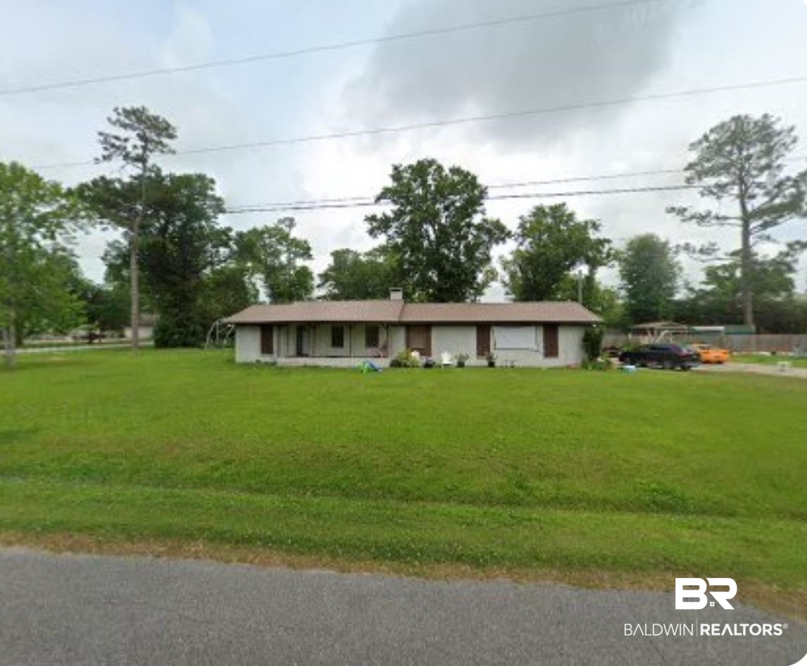 Ranch-style home featuring a front lawn