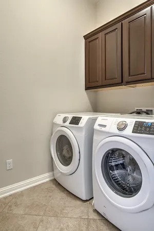 an empty room that has a window and a ceiling fan