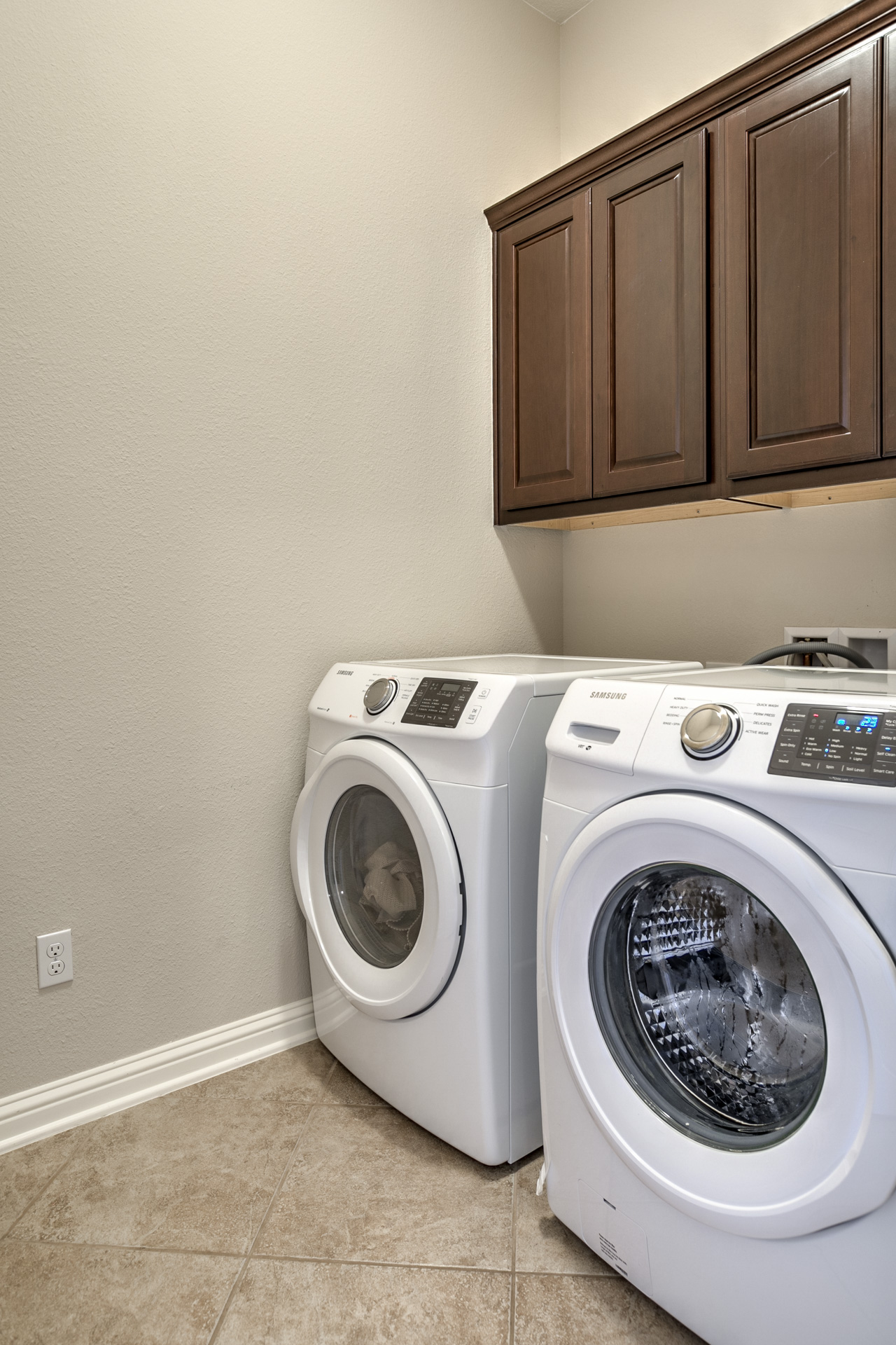 3667 Rosalina Loop Round Rock, TX 78665 - Photo 13 of 26 Laundry area featuring cabinet space, washing machine and clothes dryer, and light tile patterned flooring