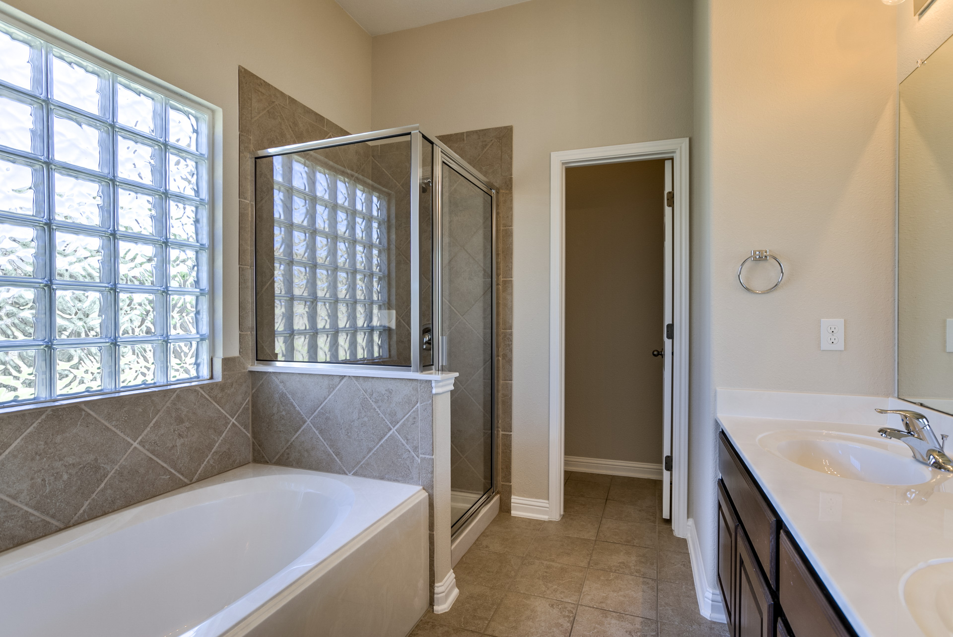 3667 Rosalina Loop Round Rock, TX 78665 - Photo 17 of 26 Full bath featuring a garden tub, a stall shower, double vanity, and light tile patterned flooring