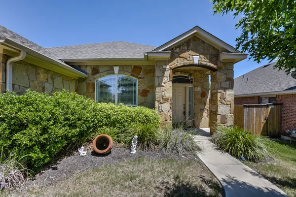 front view of a house with a garden