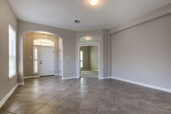 a view of a hallway with wooden shelves