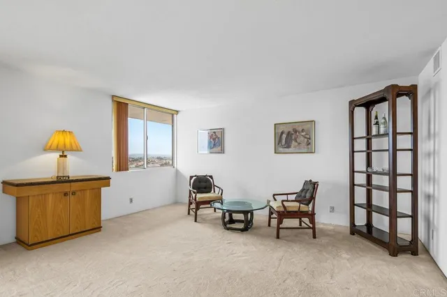 a view of a workspace with furniture and window