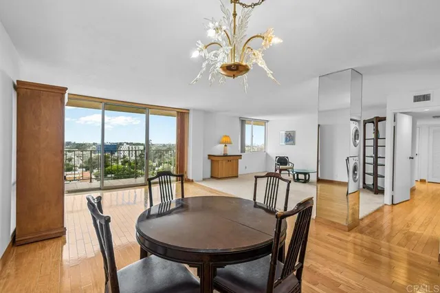 a view of a dining room with furniture window and wooden floor