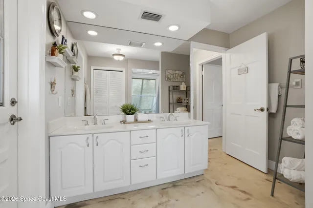 a living room with patio furniture and a floor to ceiling window
