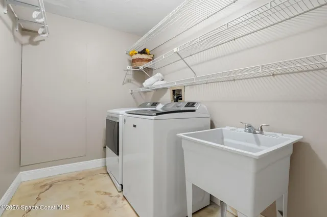 a view of patio with table and chairs and potted plants