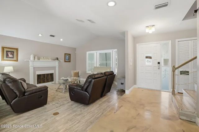 a living room with furniture a fireplace a flat screen tv and a fireplace