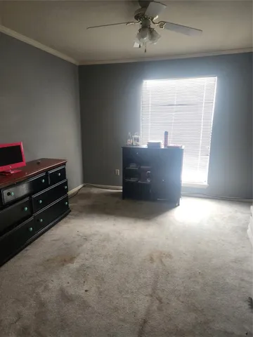 a bedroom with a bed and a lamp