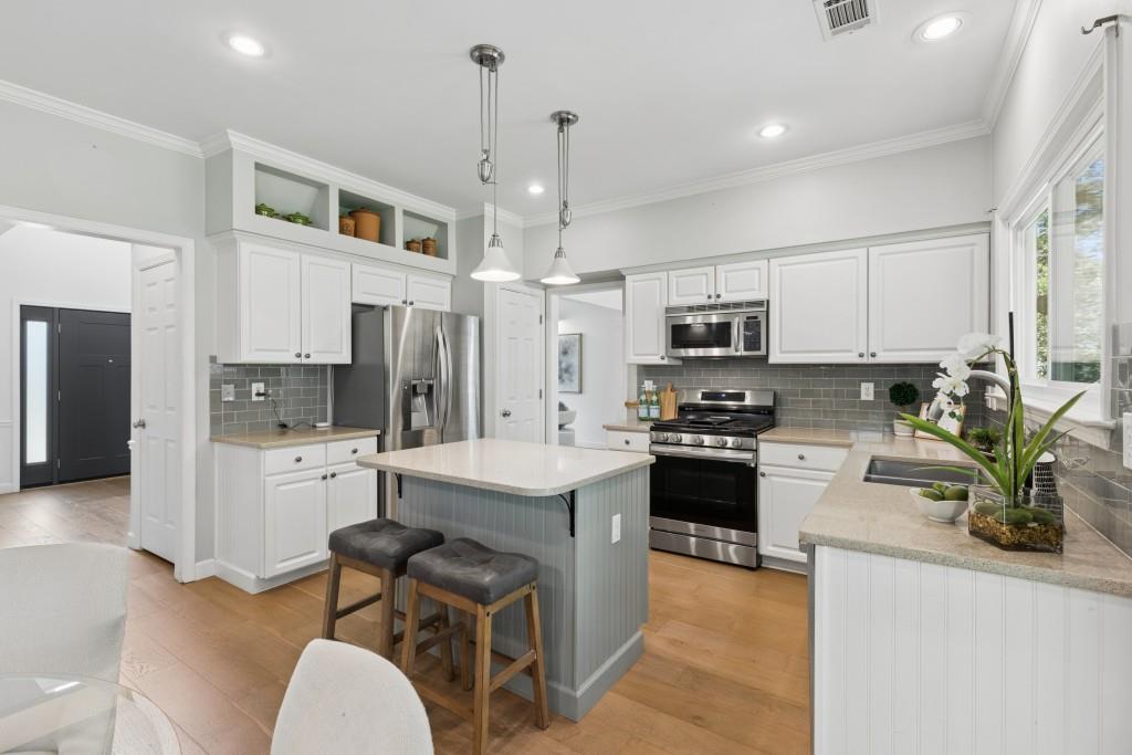 2120 Traywick Chase Alpharetta, GA 30004 - Photo 13 of 54 a kitchen with stainless steel appliances granite countertop a refrigerator oven a sink dishwasher and white cabinets with wooden floor