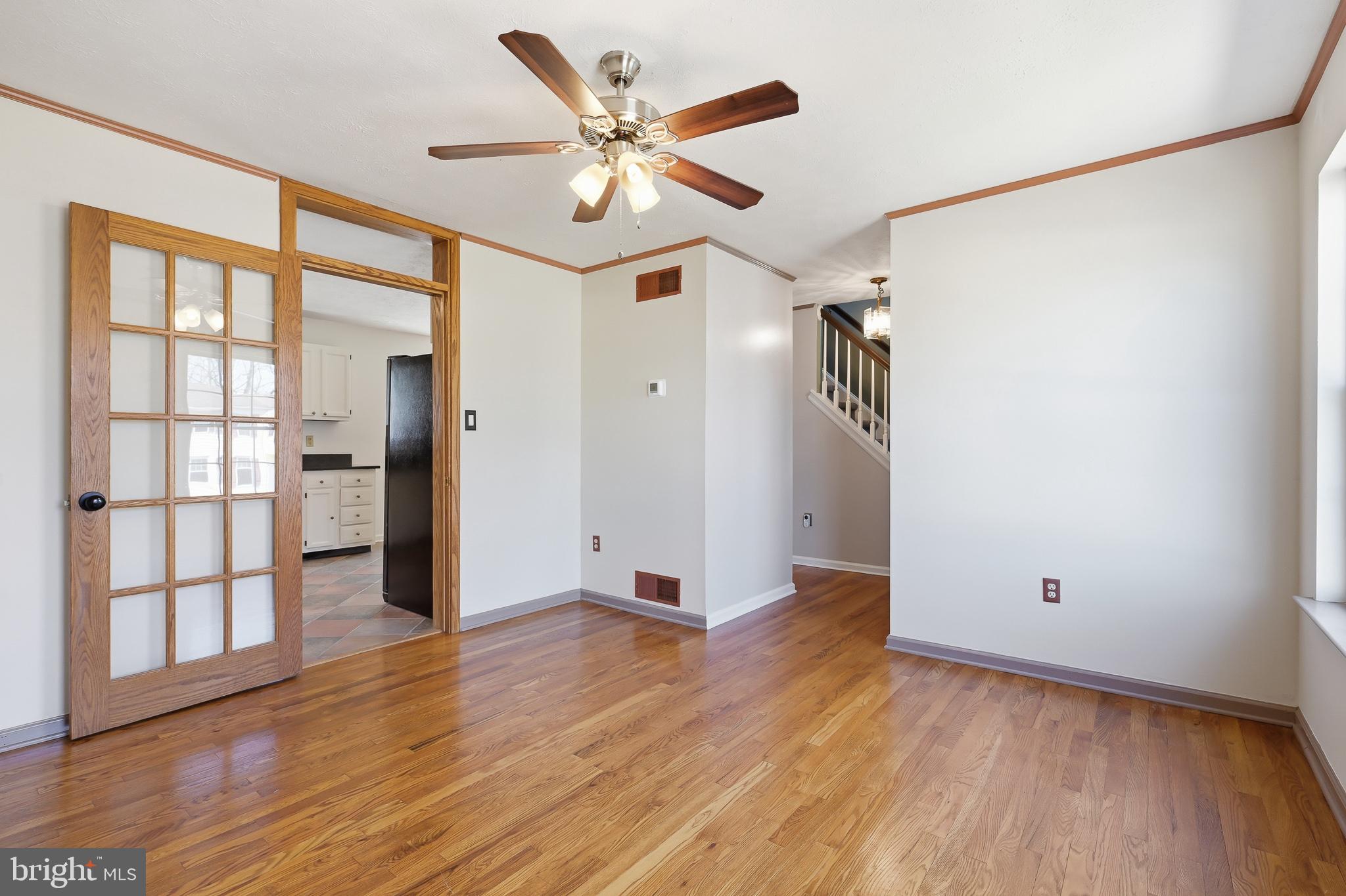 118 Liberty Lane Elkton, MD 21921 - Photo 6 of 31 an empty room with wooden floor and a ceiling fan
