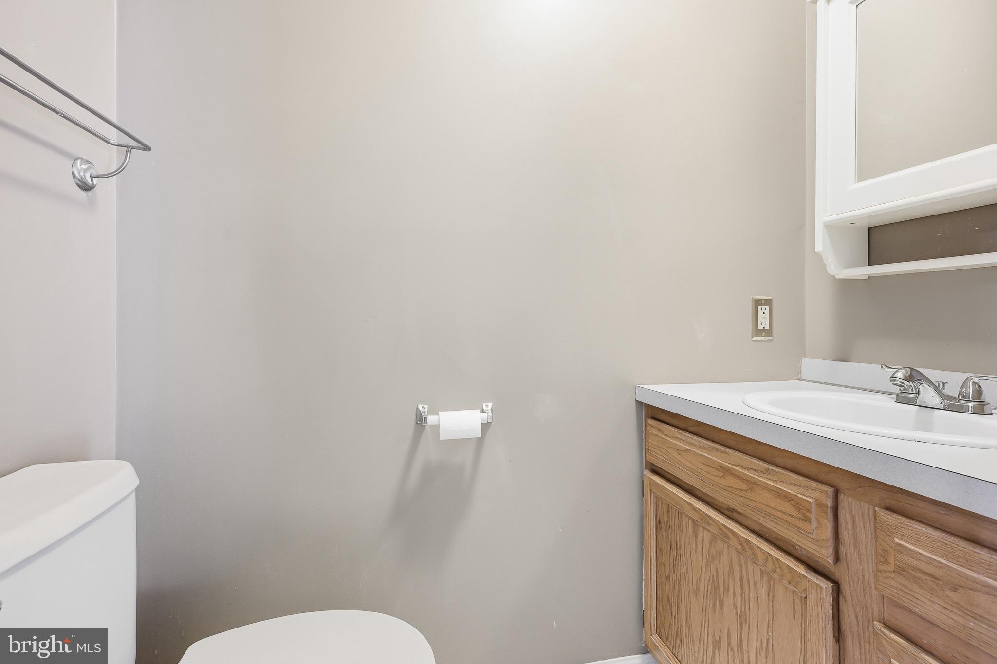 118 Liberty Lane Elkton, MD 21921 - Photo 7 of 31 a bathroom with a granite countertop sink a toilet and a mirror