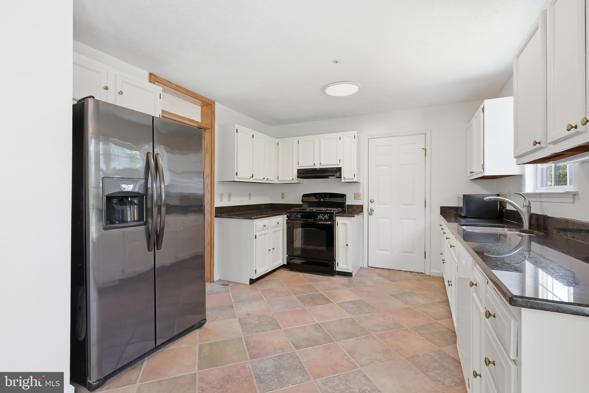 118 Liberty Lane Elkton, MD 21921 - Photo 8 of 31 a kitchen with granite countertop a refrigerator and a sink