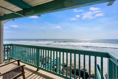 a balcony with a table and chairs
