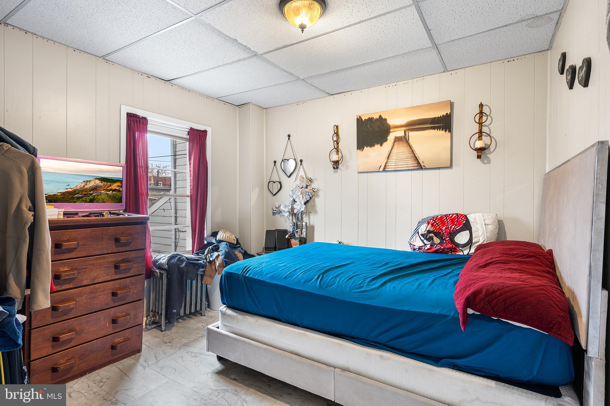 707 East 5th Street Bethlehem, PA 18015 - Photo 11 of 22 a bedroom with a bed and a bookshelf