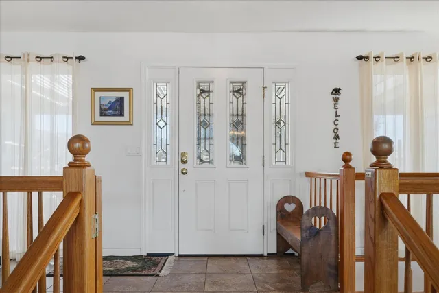 a living room with furniture fireplace and a large window