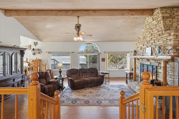 a living room with furniture a fireplace and a flat screen tv