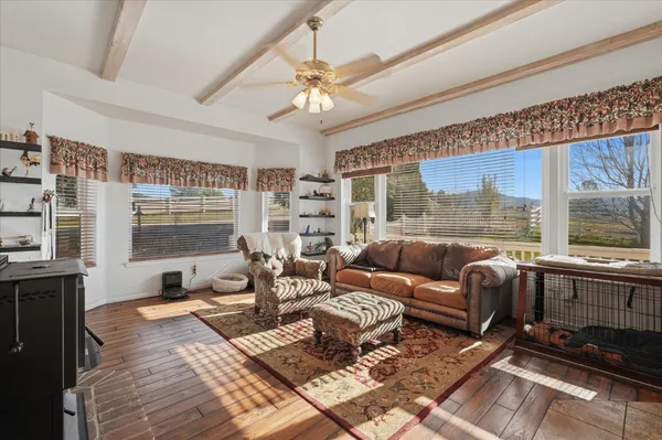a bedroom with furniture and a large window