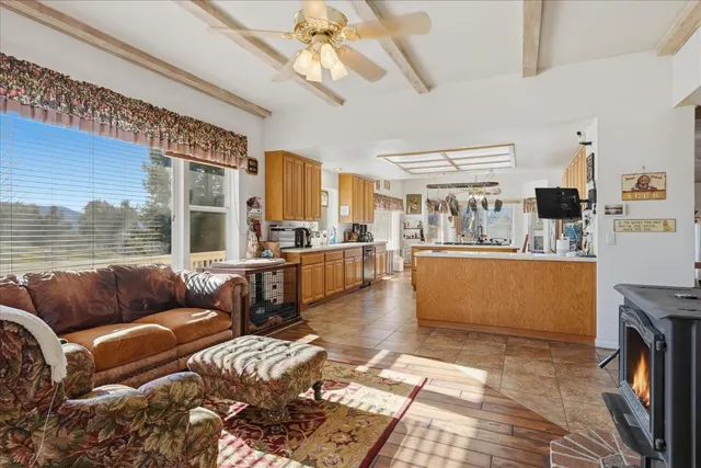 a large white kitchen with a large window