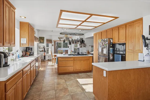 a kitchen with stainless steel appliances a refrigerator and a stove