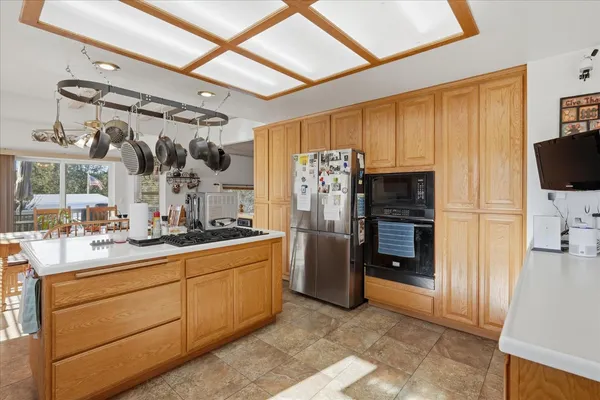 a kitchen with stainless steel appliances granite countertop a sink stove and cabinets