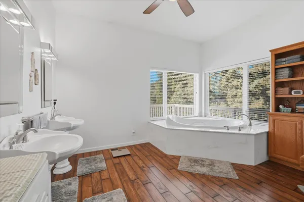 a bathroom with bathtub and next to a window