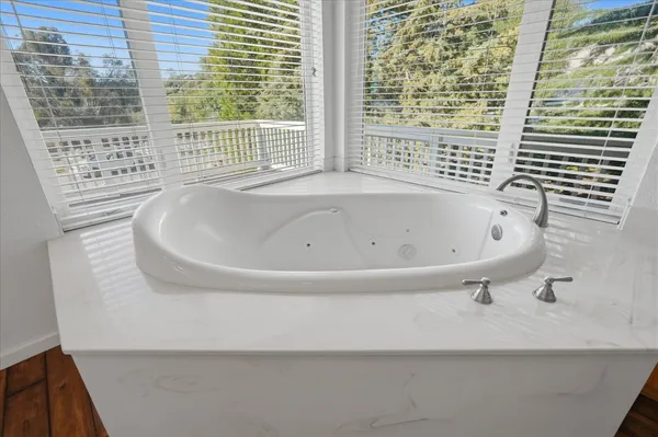 a view of balcony with wooden floor and fence