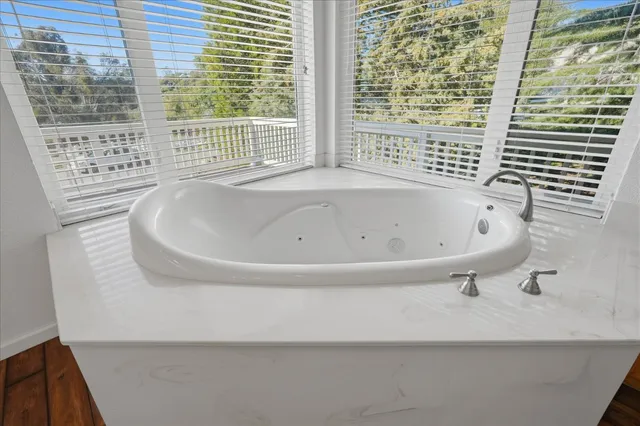 a view of balcony with wooden floor and fence