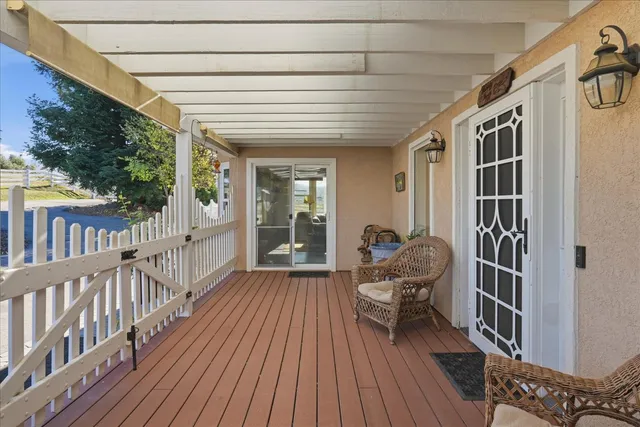 a view of a hallway with entryway wooden floor and front door
