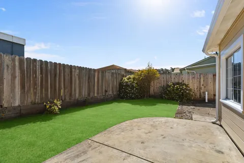 a view of a garden with wooden fence
