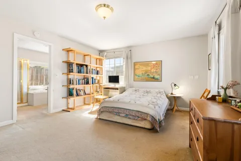 a bedroom with a bed furniture and a book shelf