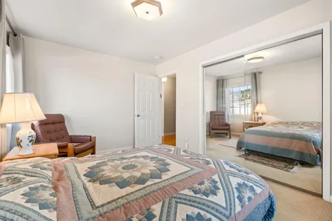 a bedroom with a bed and a lamp