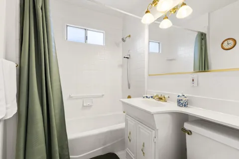 a bathroom with a bath tub a sink and a mirror