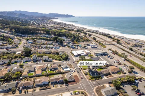 an aerial view of residential building and ocean
