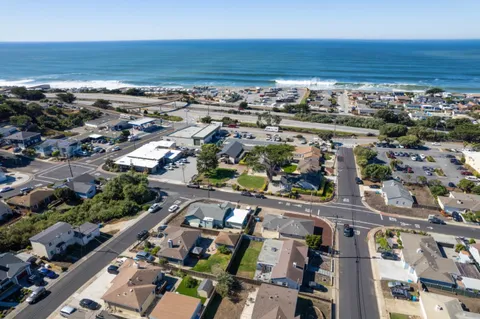an aerial view of a city with ocean view