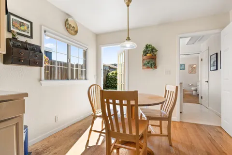 a view of a dining room with furniture window and wooden floor