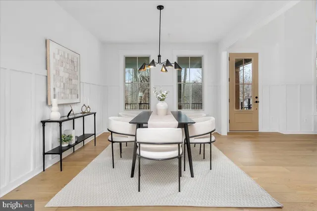 a dining room with furniture a fireplace and wooden floor