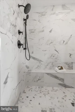 a bathroom with a sink a mirror and shower